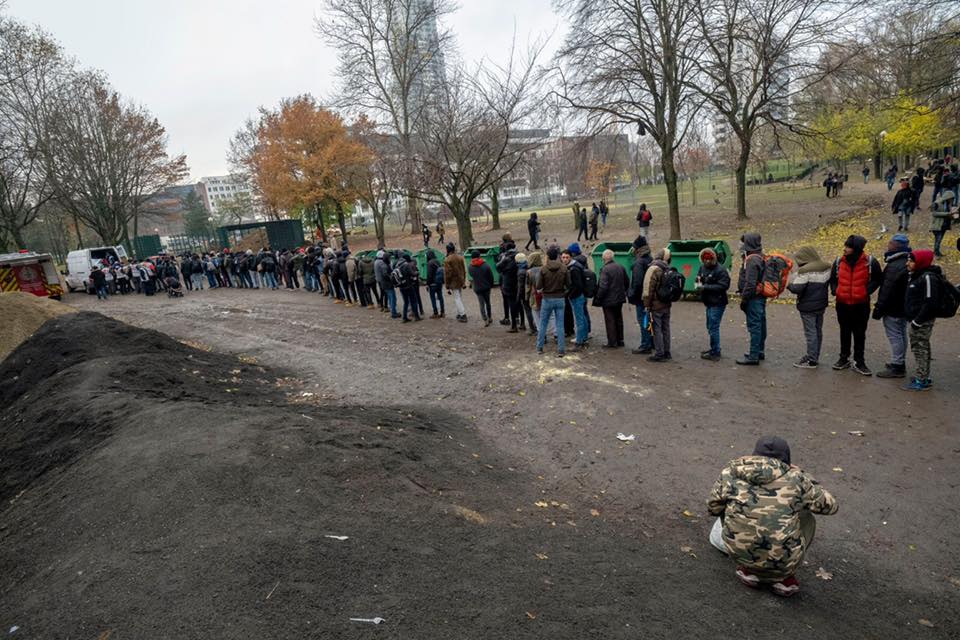 Refugees and volunteers laugh the queue away in Brussels